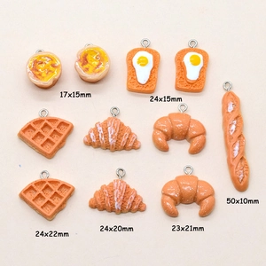 Set of 11 miniature resin food charms including waffles and croissants with size labels