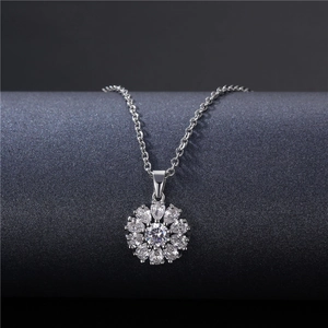 Elegant silver snowflake pendant necklace with sparkling cubic zirconia on a dark base