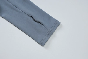 Detail shot of the thumbhole cuff on this grey blue long sleeve ruched dress