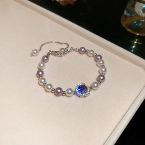 Detail of zircon manta rose pearl necklace with purple beads and sparkling diamond buckle