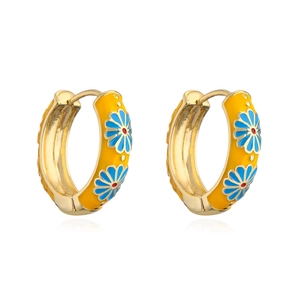 Detail of yellow enamel hoop earring featuring small floral daisy patterns and gold plating