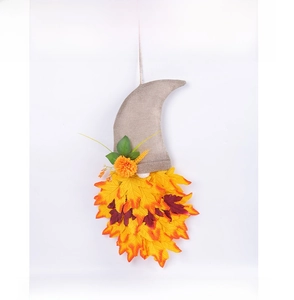 Detailed close-up of autumn gnome hat wreath with maple leaves for Thanksgiving decor