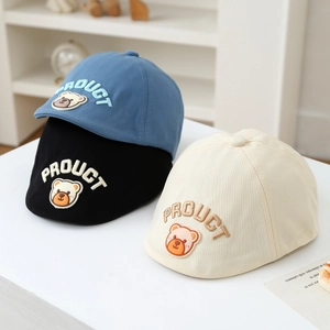 Detailed embroidery of bear patch and letters on kids cotton newsboy caps in three colors