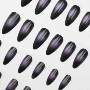Almond stiletto press-on nails featuring a deep purple cat-eye magnetic gradient finish