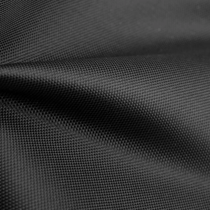 Macro detail of high-density black waterproof oxford fabric on tactical vest chest bag
