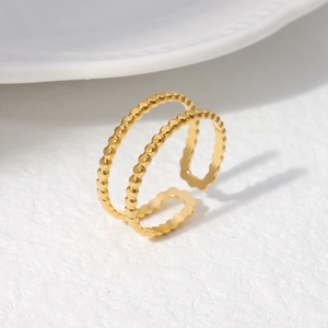 Macro detail of gold-plated stainless steel double-row beaded adjustable open ring