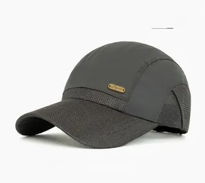 Detail of gray mesh baseball cap showing breathable fabric and gold metal logo plate