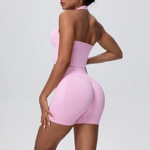 Rear view of pink seamless yoga set showing halter open back and scrunch butt shorts