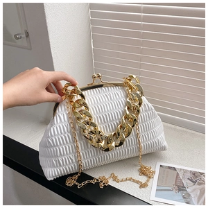 Detailed shot of white pleated handbag with dual gold chain straps and metal clasp