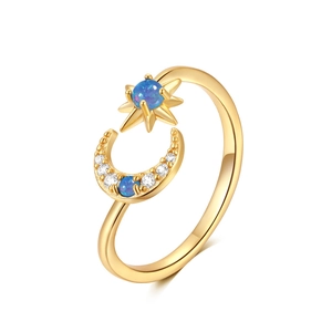 Detailed close-up of gold open ring featuring celestial star and moon with opal inlay