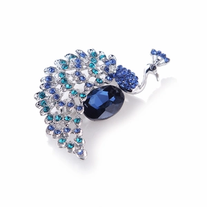 Detailed view of peacock brooch with dark blue crystal and rhinestones on silver alloy