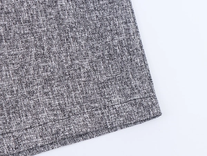 Detailed view of gray tweed fabric texture and precise stitching on the pants
