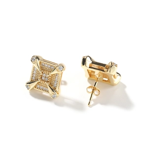Detailed macro view of gold dragon claw earrings featuring square zircon inlay