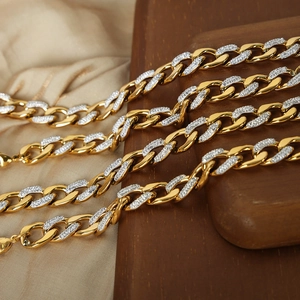 Gold-plated Cuban link necklace set with sparkling pavé diamonds on silk background