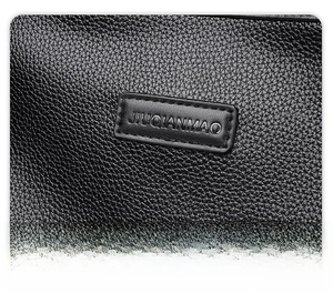 Close-up of black litchi grain leather texture and embossed rectangular brand logo tag