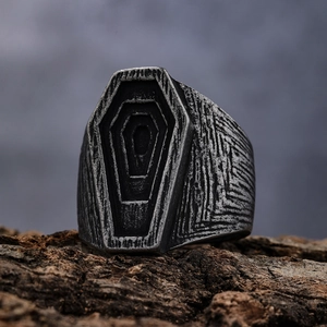 Macro shot of gothic coffin ring showing vintage silver texture and punk details