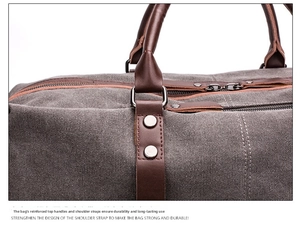 Detail of gray canvas travel bag showing reinforced leather handles and metal rivets