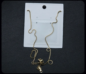 Detail of golden box chain necklace with adjustable tail chain and lobster clasp