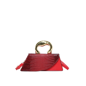 Red crocodile pattern handbag with unique irregular shape and gold metal handle