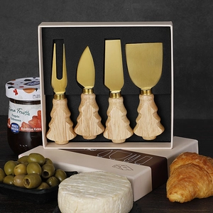 Detail of 4-piece gold cheese knife set with Christmas tree wooden handles in gift box