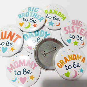 Set of colorful Baby Shower tinplate badges for gender reveal party with family titles