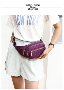 Detail of purple quilted nylon fanny pack with golden zippers and multi-zipper pockets