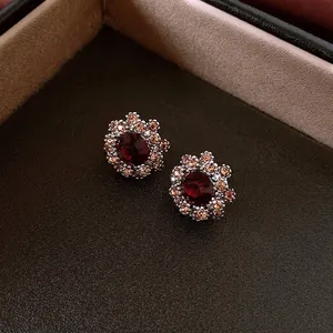 Vintage floral stud earrings with deep red stone and champagne crystals in a silver base