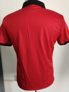 Rear view of red men's polo shirt with contrast black collar and ribbed cuffs detail