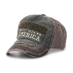 Detail of vintage New York baseball cap with distressed brim and patchwork cotton fabric