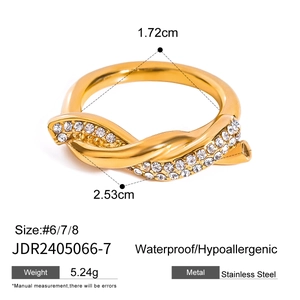 Macro view of gold-plated stainless steel wrap ring with sparkling zircon stones