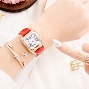 Close-up of women's square rhinestone watch with red leather strap and star bracelet