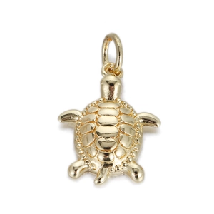 Macro detail of golden turtle pendant with textured shell and polished metal surface