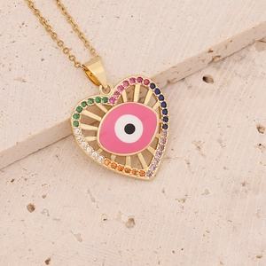 Golden heart necklace with rainbow gemstones and evil eye enamel charm on stone base