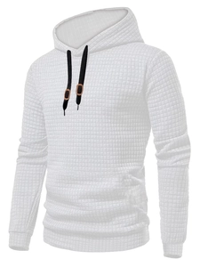Detail of white waffle knit texture and black drawstrings on a men's hooded sweatshirt