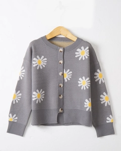 Detail of grey knitted cardigan showing white daisy embroidery and wooden buttons