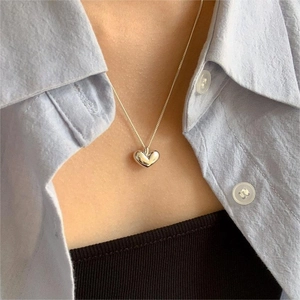 Elegant 925 sterling silver heart pendant necklace shown on model with light blue shirt