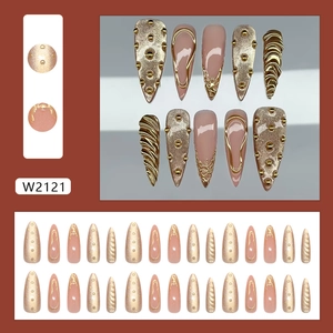 Luxury cat-eye press-on nails with golden metallic accents and long stiletto shape