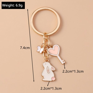 Detailed view of cartoon rabbit and heart keychain with dimensions and weight labels