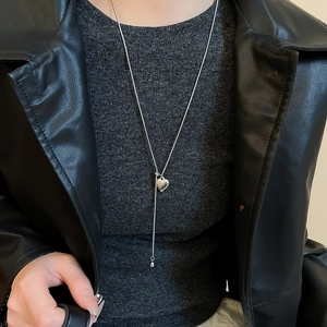 Silver Y-shaped heart pendant necklace shown on model with chic leather jacket