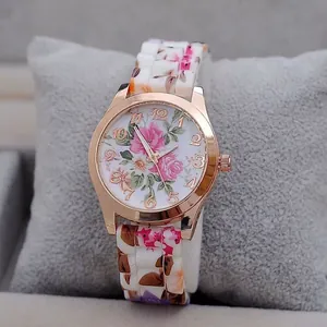 Close-up of floral print watch with rose gold bezel and pink flower pattern on the strap