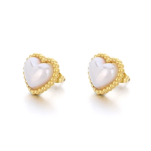Golden heart stud earrings with white pearlescent stone and beaded metal edges on white background