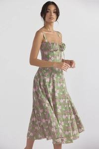 Close-up detail of green floral midi dress with spaghetti straps and tie-front bodice