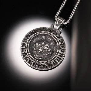 Detailed macro view of vintage wolf head relief on a stainless steel round pendant necklace