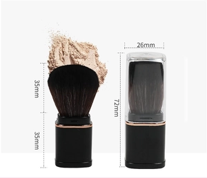 Detail showing dimensions of a portable retractable makeup brush in pink and gold
