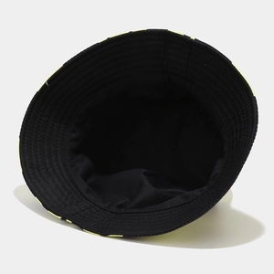 Detail of black reversible bucket hat showing interior sweatband and neon yellow rim