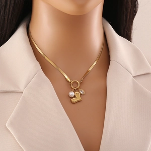 Golden heart pendant necklace with pearls and zircon on snake chain with front toggle clasp
