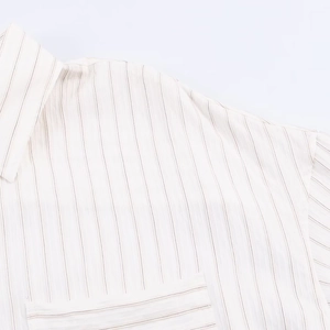Detailed view of white striped shirt neckline, shoulder seams and pocket stitching details