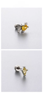 Detailed macro view of yellow opal fish stud and rhombus earring with screw back