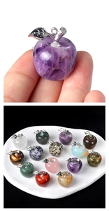 Macro shot of natural crystal apple pendants in purple and various stone colors