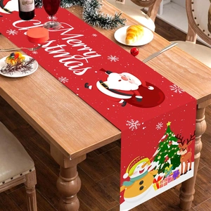 Festive red Christmas table runner featuring Santa, snowman and reindeer on wooden table